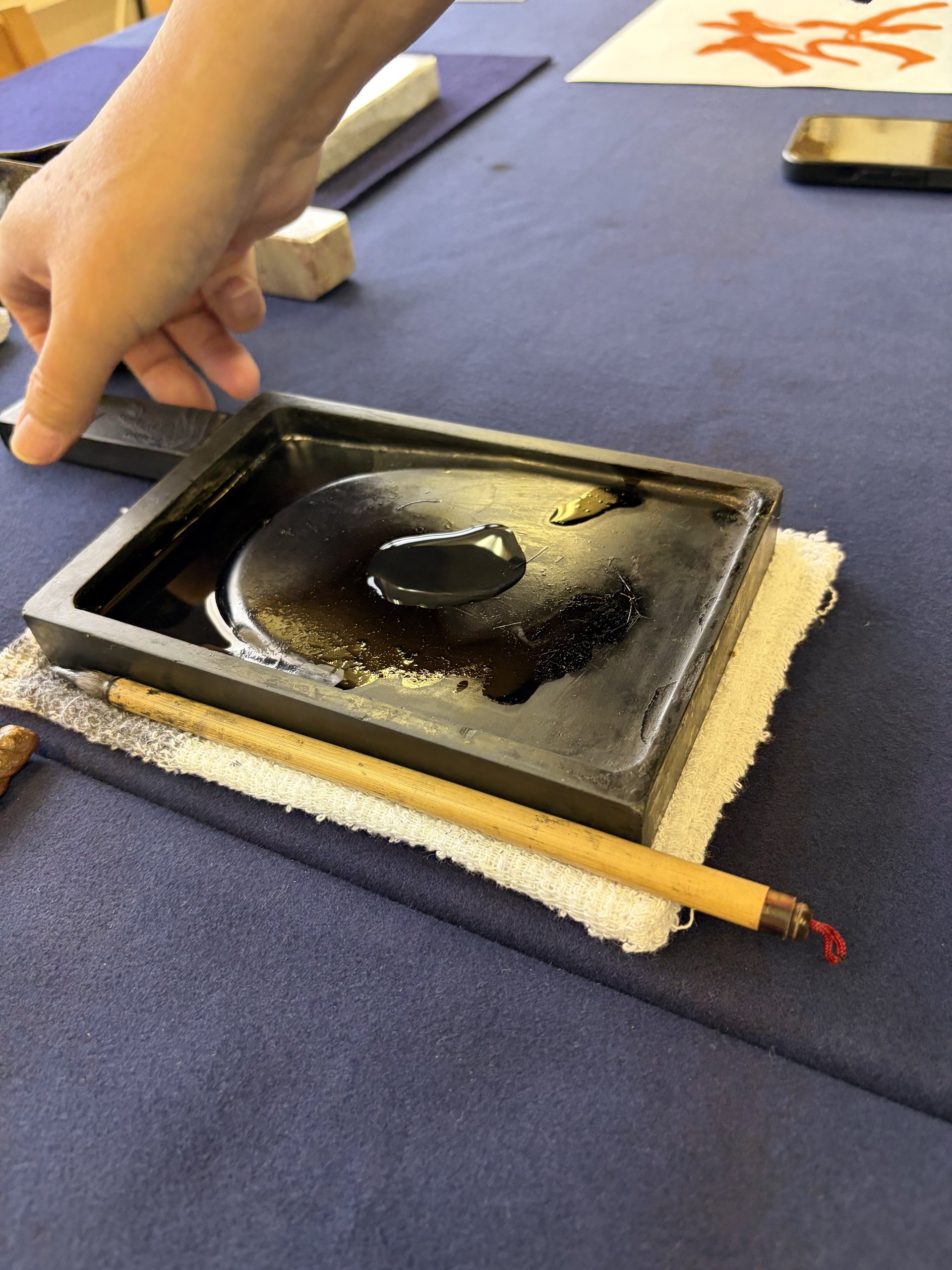 Close-up of ink stone and brush